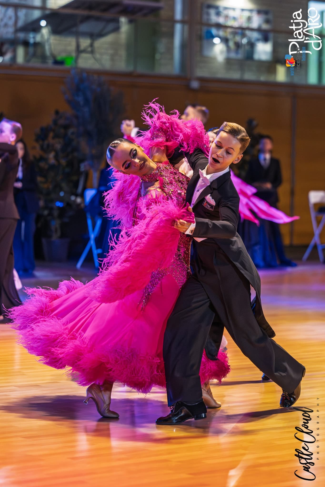 Ballroom pair in vibrant competition performance