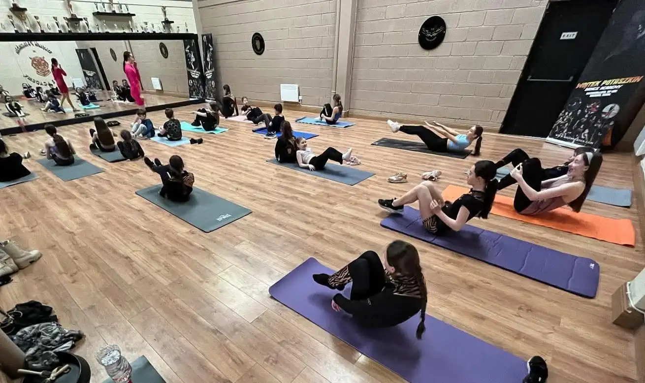 Students in a conditioning and warm-up session
